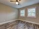 Bedroom featuring wood-look floors and two bright, shuttered windows at 1675 Bouldercliff Se Ct, Atlanta, GA 30316