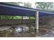 Large carport area with concrete flooring, brick supports and rear door at 1675 Bouldercliff Se Ct, Atlanta, GA 30316