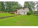 Charming two-story home with a well-manicured lawn and a convenient carport at 1675 Bouldercliff Se Ct, Atlanta, GA 30316