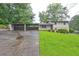 Charming home with a large front lawn, connected to a carport and long driveway at 1675 Bouldercliff Se Ct, Atlanta, GA 30316