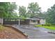 Two-story home with an attached carport and driveway leading to the main structure at 1675 Bouldercliff Se Ct, Atlanta, GA 30316