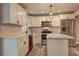 Bright kitchen with white cabinets, granite countertops, and stainless steel appliances at 1675 Bouldercliff Se Ct, Atlanta, GA 30316