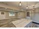Open concept living and kitchen area with marble island and contemporary light fixtures at 1675 Bouldercliff Se Ct, Atlanta, GA 30316