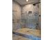 Modern walk-in shower with marble tile and a built-in niche and bench at 1675 Bouldercliff Se Ct, Atlanta, GA 30316