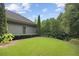 Beautiful backyard showcasing lush greenery, including a manicured lawn and mature trees for added privacy at 308 Shade Tree Cir, Woodstock, GA 30188