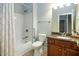 Bright bathroom with a shower-tub combo, granite vanity, and classic fixtures at 308 Shade Tree Cir, Woodstock, GA 30188
