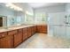 Bathroom with double vanity, stone countertops, glass enclosed shower, and ceramic tile floors at 308 Shade Tree Cir, Woodstock, GA 30188