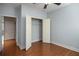 Bedroom featuring hardwood floors, a ceiling fan, and a walk-in closet with shelving at 308 Shade Tree Cir, Woodstock, GA 30188