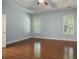 Bedroom with hardwood floors, tray ceilings, plantation shutters, and neutral-colored walls at 308 Shade Tree Cir, Woodstock, GA 30188