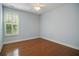 Comfortable bedroom with hardwood floors, a ceiling fan, and natural light through shuttered windows at 308 Shade Tree Cir, Woodstock, GA 30188