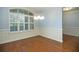 Refined dining room featuring hardwood floors, plantation shutters, and elegant wainscoting detail at 308 Shade Tree Cir, Woodstock, GA 30188