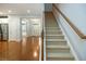 Inviting entryway and staircase with hardwood floors and natural light at 308 Shade Tree Cir, Woodstock, GA 30188