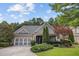 Charming home featuring a well-manicured lawn, a two-car garage, and beautiful landscaping at 308 Shade Tree Cir, Woodstock, GA 30188