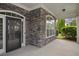 Inviting front porch with stone accents, a stylish door, and a cozy outdoor space at 308 Shade Tree Cir, Woodstock, GA 30188