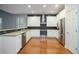 Modern kitchen featuring white cabinetry, stainless steel appliances, and granite countertops at 308 Shade Tree Cir, Woodstock, GA 30188