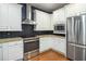 Modern kitchen with white cabinets, stainless steel appliances, granite countertops, and a stylish subway tile backsplash at 308 Shade Tree Cir, Woodstock, GA 30188