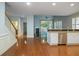 Open-concept kitchen with stainless steel appliances, hardwood floors, and ample counter space at 308 Shade Tree Cir, Woodstock, GA 30188