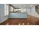 Open-concept living space featuring hardwood floors, a breakfast bar, a staircase, and wainscotting at 308 Shade Tree Cir, Woodstock, GA 30188