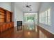 Spacious living room with vaulted ceilings, hardwood floors, fireplace, built-in shelving, and plantation shutters at 308 Shade Tree Cir, Woodstock, GA 30188