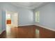 Spacious main bedroom with hardwood floors, plantation shutters, neutral walls, and an en-suite bathroom at 308 Shade Tree Cir, Woodstock, GA 30188