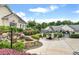 Relaxing pool area featuring a stone waterfall, comfortable seating, and lush landscaping, perfect for outdoor enjoyment at 308 Shade Tree Cir, Woodstock, GA 30188