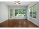 Bright sunroom with hardwood floors and many large windows providing abundant natural light and views of the landscape at 308 Shade Tree Cir, Woodstock, GA 30188