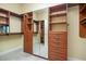 Spacious walk-in closet with custom wooden shelving and drawers, and a full-length mirror at 308 Shade Tree Cir, Woodstock, GA 30188