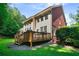 This backyard features a wooden deck, green lawn, and lush foliage, perfect for outdoor relaxation and entertaining at 5410 Cottage Farm Rd, Alpharetta, GA 30022