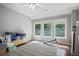 Relaxing bedroom with three bright windows and a vintage rug at 5410 Cottage Farm Rd, Alpharetta, GA 30022