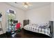 This cozy bedroom features a ceiling fan, a workstation, and a large window at 5410 Cottage Farm Rd, Alpharetta, GA 30022