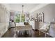 Formal dining room with elegant light fixture and a beautiful view to the outdoors at 5410 Cottage Farm Rd, Alpharetta, GA 30022