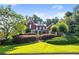 Charming two-story brick home with manicured landscaping and a welcoming front yard at 5410 Cottage Farm Rd, Alpharetta, GA 30022