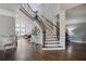 Elegant foyer with a grand staircase, hardwood floors, and neutral wall paint at 5410 Cottage Farm Rd, Alpharetta, GA 30022