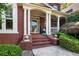 Inviting front porch with brick steps and white columns leads to the front door at 5410 Cottage Farm Rd, Alpharetta, GA 30022