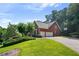 Spacious two-car garage and a beautiful backyard with verdant green grass at 5410 Cottage Farm Rd, Alpharetta, GA 30022