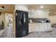 Finished basement kitchen area features a large refrigerator, a sink, and white cabinets at 5410 Cottage Farm Rd, Alpharetta, GA 30022
