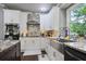 Modern kitchen with white cabinets, stainless steel appliances, and granite countertops at 5410 Cottage Farm Rd, Alpharetta, GA 30022