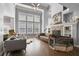 Bright living room with tall windows, fireplace, and built-in shelves at 5410 Cottage Farm Rd, Alpharetta, GA 30022