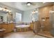 Luxurious bathroom with a soaking tub, separate shower, and double vanity at 5410 Cottage Farm Rd, Alpharetta, GA 30022