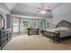 Spacious bedroom featuring bay windows, trey ceilings, a ceiling fan, and neutral colors at 5410 Cottage Farm Rd, Alpharetta, GA 30022