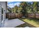 Fenced backyard with a concrete patio, small tree, and well-maintained grass at 7086 Gladstone Cir, Lithonia, GA 30038