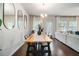 Bright dining area featuring wood floors, modern lighting, and stylish decor at 7086 Gladstone Cir, Lithonia, GA 30038