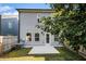 Back exterior of the home with a small patio, lawn and privacy fence at 7086 Gladstone Cir, Lithonia, GA 30038