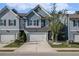 Charming townhome with a blue exterior, two-car garage, and well-manicured front yard at 7086 Gladstone Cir, Lithonia, GA 30038