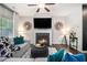 Comfortable living room with a fireplace, ceiling fan, and stylish decor at 7086 Gladstone Cir, Lithonia, GA 30038