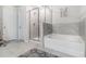 Main bathroom with walk-in shower and soaking tub, complemented by stylish tile work at 7086 Gladstone Cir, Lithonia, GA 30038
