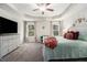 Relaxing main bedroom with tray ceilings, a ceiling fan, and comfortable furnishings at 7086 Gladstone Cir, Lithonia, GA 30038
