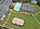 Community featuring a swimming pool, volleyball court, and manicured landscaping from an aerial view at 1150 Collier Nw Rd # B5, Atlanta, GA 30318