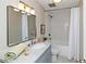 Updated bathroom with a stylish vanity, marble countertop, and a tiled shower-tub combo at 1150 Collier Nw Rd # B5, Atlanta, GA 30318