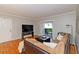 Cozy living room features hardwood floors, a comfortable sofa, and a view of the outdoor balcony at 1150 Collier Nw Rd # B5, Atlanta, GA 30318